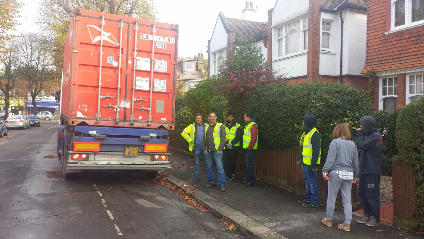 Excess Luggage staff loading a shipping container